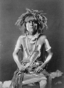 Honovi-Walpi snake priest, with Totkya Day painting, c1910. Creator: Edward Sheriff Curtis