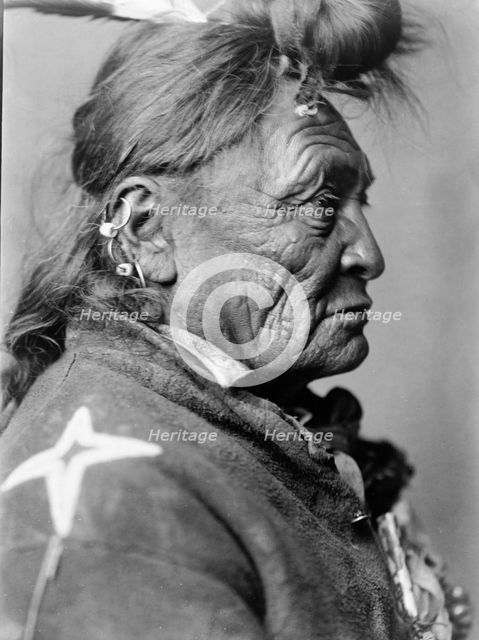Hoop On the Forehead, Crow Indian, Montana, head-and-shoulders portrait, facing right, c1908. Creator: Edward Sheriff Curtis.