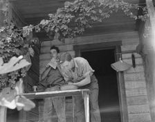 Hop farmer's sons, washing for noon meal on back porch, Independence, Polk County, Oregon, 1939. Creator: Dorothea Lange