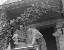 Hop farmer's sons, washing for noon meal on back porch, Independence, Polk County, Oregon, 1939. Creator: Dorothea Lange