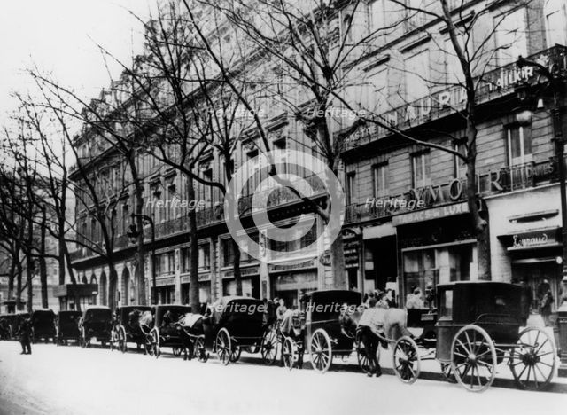 Horse-drawn cabs on a street during the German occupation, Paris, 1944. Artist: Unknown