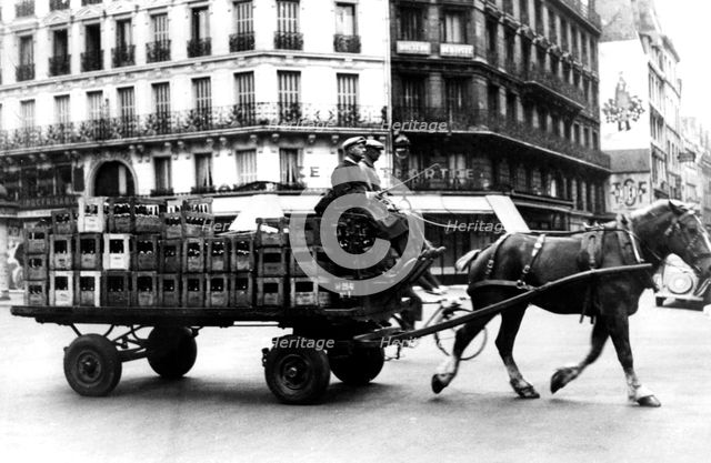 Horse-drawn cart carrying crates of drink, German-occupied Paris, July 1940. Artist: Unknown