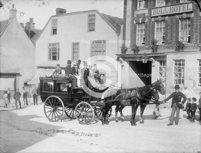 Horse drawn bus with passengers outside the Bull Hotel, Burford High Street, Oxon, c1860-c1922. Artist: Henry Taunt