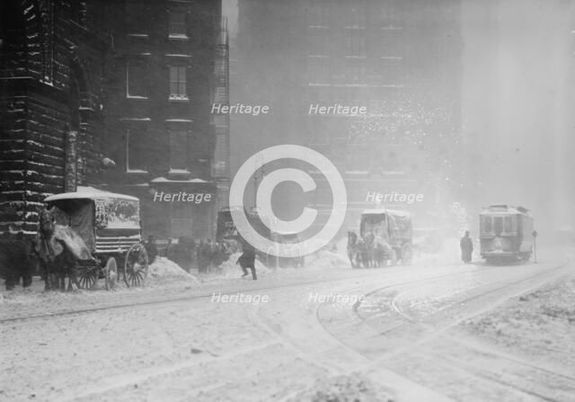 Horse-drawn wagons on snowy street, NY snow storm, 1910. Creator: Bain News Service.