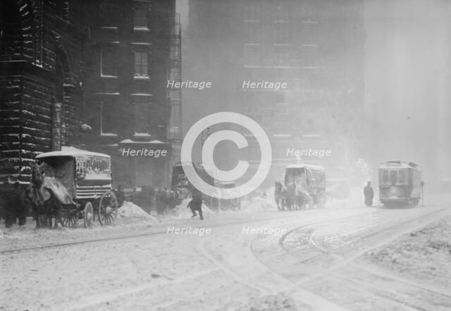 Horse-drawn wagons on snowy street, NY snow storm, 1910. Creator: Bain News Service.