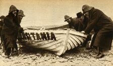 Hauling up one of the Lusitania's boats Ireland, May 1915, (1933). Creator: Unknown