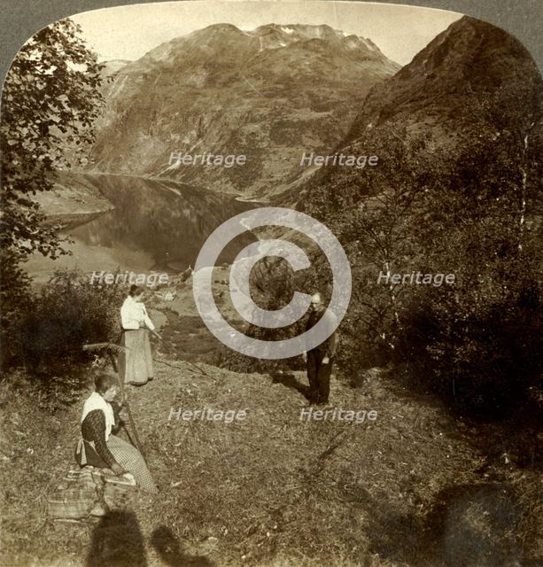 'Haying on mountain shelf high above Marok village and mirror-clear Geirangerfjord, Norway', c1905 Creator: Unknown.