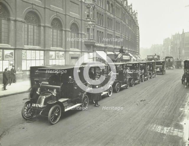 Hackney carriages and drivers at a taxi rank, Bishopsgate, London, 1912. Artist: Unknown.