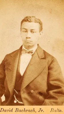 Half-figure portrait of man wearing bow tie, c1870-c1879. Creator: David Bachrach