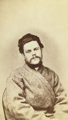 Half-length portrait of a man, dressed in convict clothing, facing front, between 1880 and 1886. Creator: Unknown