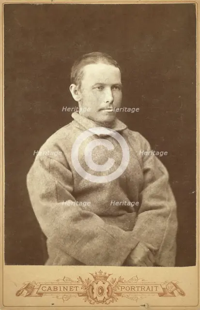 Half-length portrait of a man in convict coat, seated, facing right, between 1880 and 1886. Creator: Unknown.