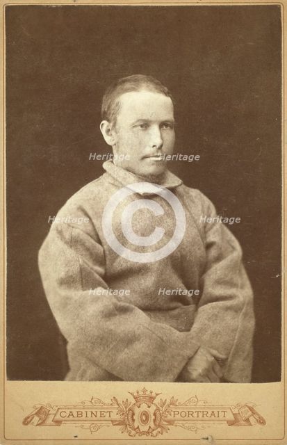Half-length portrait of a man in convict coat, seated, facing right, between 1880 and 1886. Creator: Unknown.