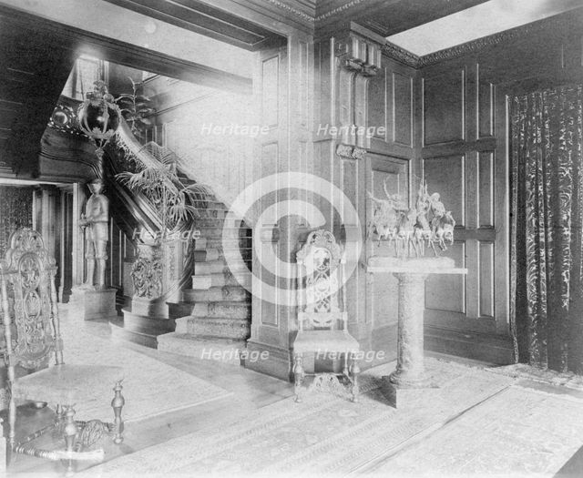 Hall and stairway, with suit of armor at left, and statue of cow..., Greenwich, Connecticut, 1908. Creator: Frances Benjamin Johnston.