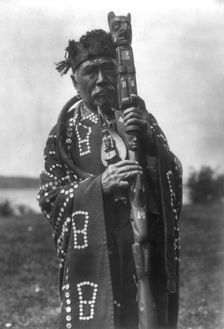 Hamasaka in Tluwulahu costume with speaker's staff-Qagyuhl [principal chief], c1914. Creator: Edward Sheriff Curtis