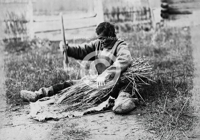 Hammering the sheaf, 1890.  Creator: Unknown.