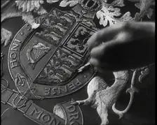 Hand of Seamstress Sewing a Royal Emblem, 1937. Creator: British Pathe Ltd