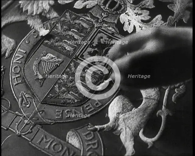 Hand of Seamstress Sewing a Royal Emblem, 1937. Creator: British Pathe Ltd.