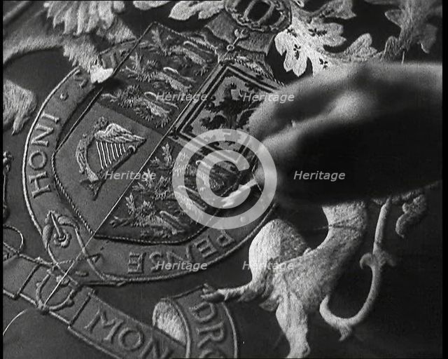 Hand of Seamstress Sewing a Royal Emblem, 1937. Creator: British Pathe Ltd.