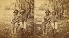 Happy little nig's, [Two boys sitting on a barrel in a field], (1868-1900?). Creator: Unknown