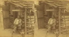 Happy little Bob. [Man playing fiddle in front of cabin], (1868-1900?). Creator: O. Pierre Havens