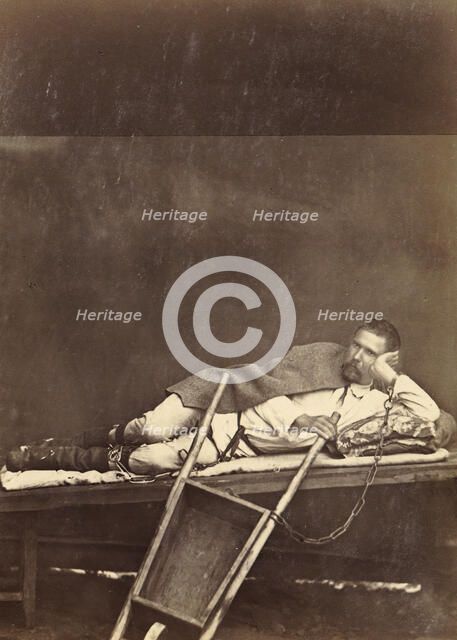Hard Labor Convict Lying on a Bunk While Chained to a Wheelbarrow, 1891. Creator: Aleksei Kuznetsov.