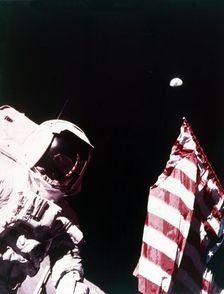 Harrison Schmitt with US flag on the surface of the Moon, Apollo 17 mission, December 1972. Creator: Eugene Cernan
