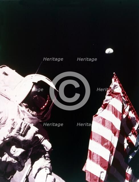 Harrison Schmitt with US flag on the surface of the Moon, Apollo 17 mission, December 1972. Creator: Eugene Cernan.