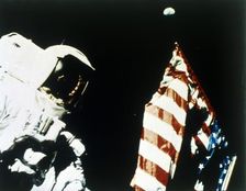 Harrison Schmitt with US flag on the surface of the Moon, Apollo 17 mission, December 1972. Creator: NASA