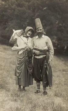 Harry Smallwood and another man stand in a field, one in drag and the other..., 1925. Creator: Unknown