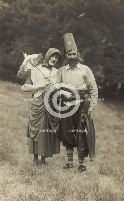 Harry Smallwood and another man stand in a field, one in drag and the other..., 1925. Creator: Unknown.
