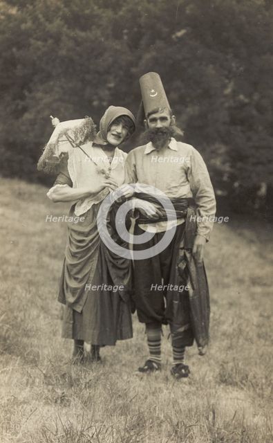 Harry Smallwood and another man stand in a field, one in drag and the other..., 1925. Creator: Unknown.
