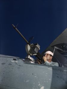 He's like to use that gun on the Axis, Naval Air Base, Corpus Christi, Texas, 1942. Creator: Howard Hollem