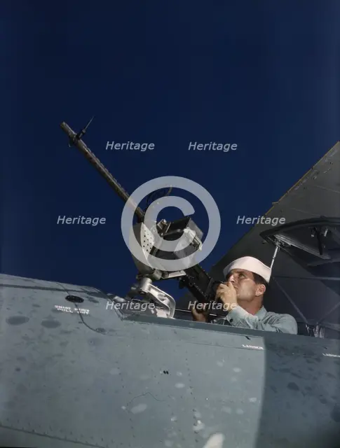 He's like to use that gun on the Axis, Naval Air Base, Corpus Christi, Texas, 1942. Creator: Howard Hollem.