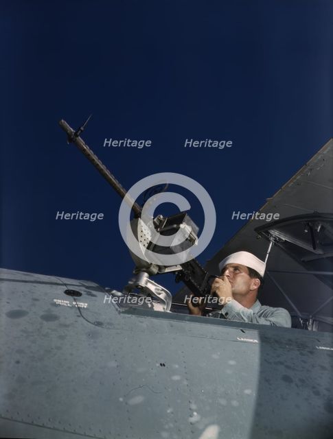 He's like to use that gun on the Axis, Naval Air Base, Corpus Christi, Texas, 1942. Creator: Howard Hollem.
