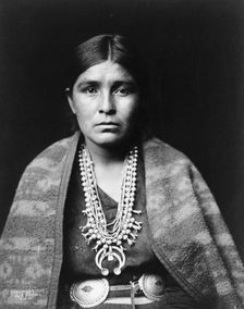 Head-and-shoulders portrait of Navajo woman, facing front, c1904. Creator: Edward Sheriff Curtis