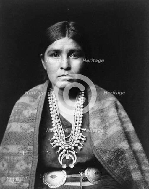 Head-and-shoulders portrait of Navajo woman, facing front, c1904. Creator: Edward Sheriff Curtis.