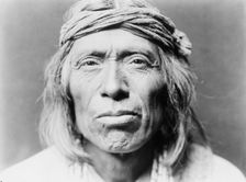Head-and-shoulders portrait of Shiwawatiwa, a Zuni Indian, facing front, c1903. Creator: Edward Sheriff Curtis
