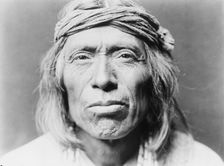 Head-and-shoulders portrait of Shiwawatiwa, a Zuni Indian, facing front, c1903. Creator: Edward Sheriff Curtis