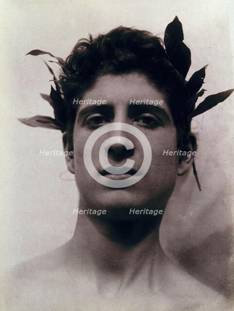 Head of a Sicilian boy posing, crowned with laurel leaves, March 1902. Creator: Count Wilhelm von Gloeden.