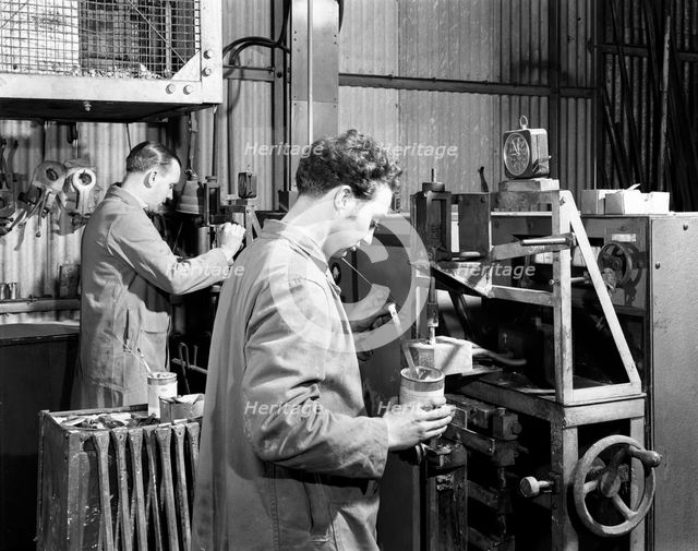 Heading at the Edgar Allen Steel Foundry, Sheffield, South Yorkshire, 1962. Artist: Michael Walters