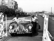 Healey Westland 2.4, Eastbourne Rally 1952, S.P.A. Freeman getting into car. Creator: Unknown
