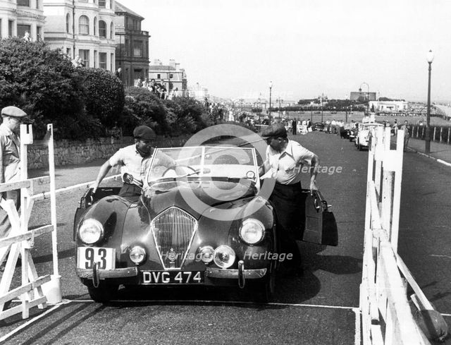 Healey Westland 2.4, Eastbourne Rally 1952, S.P.A. Freeman getting into car. Creator: Unknown.