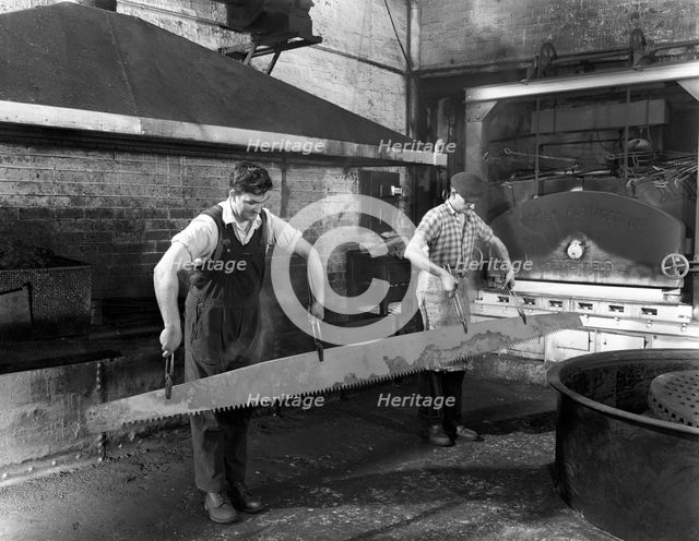 Heat treating a two metre saw blade, Slack Sellars & Co Ltd, Sheffield, South Yorkshire, 1963. Creator: Michael Walters.