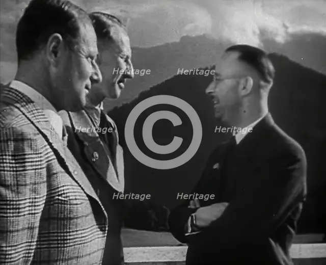 Heinrich Himmler Talking to Two Other Men, 1942. Creator: British Pathe Ltd.