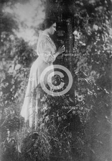 Helen Keller, standing next to tree, 1912. Creator: Bain News Service.