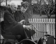 Henry and Clara Ford Sitting in an Old Motorcar, 1921. Creator: British Pathe Ltd