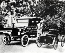 Henry Ford with old models of the Ford trademark