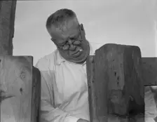 Henry Lotz closing the gate to the barns at the Midway City Dairy Association, near Santa Ana, 1937. Creator: Dorothea Lange