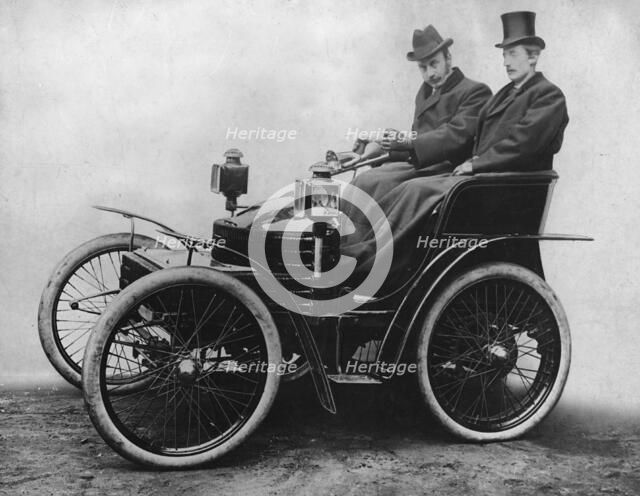Herbert Austin at tiller of first 4 wheel Wolseley 1899. Creator: Unknown.