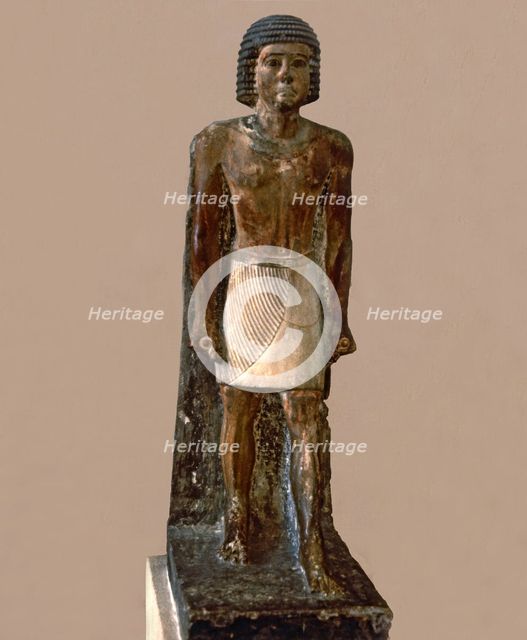 Hieratic statue of a man, made in polychromed limestone.